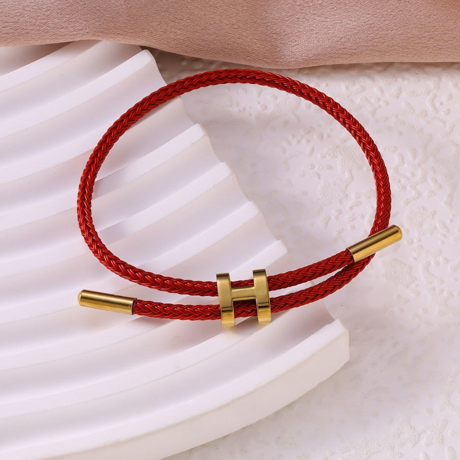 Sableau Woven Steel Bracelet in wine red, braided steel cord with a gold-plated slide clasp