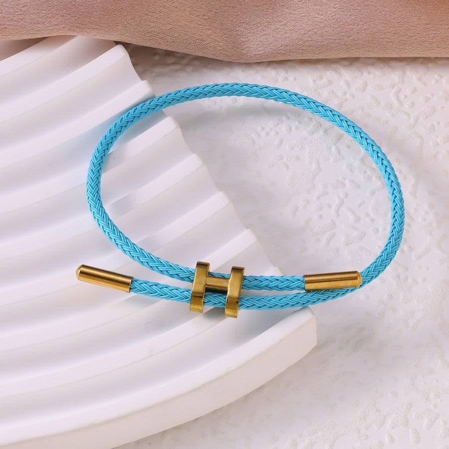 Sableau Woven Steel Bracelet in sky blue, braided steel cord with a gold-plated slide clasp