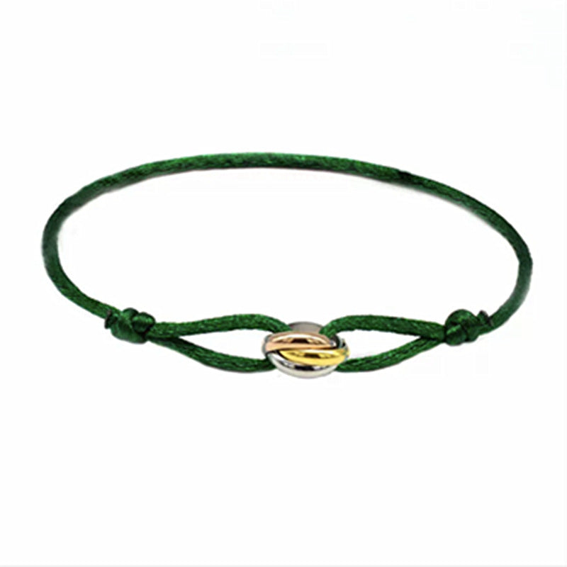 Sableau Trio Cord Bracelet in green, three-tone steel rings on an adjustable cord