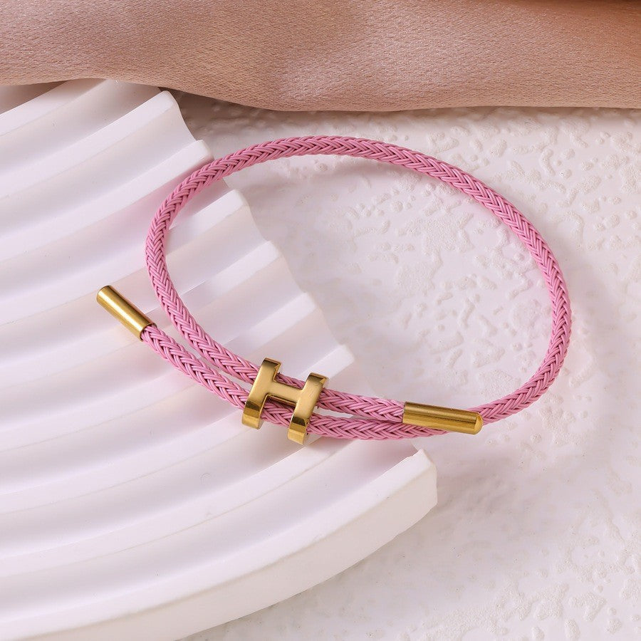 Sableau Woven Steel Bracelet in light pink, braided steel cord with a gold-plated slide clasp