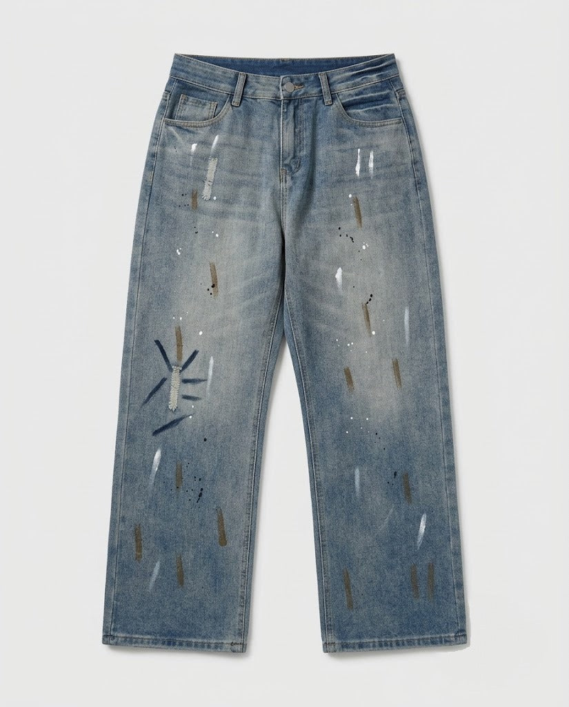 Blue paint-splatter straight-leg jeans — flat lay